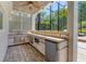 Outdoor kitchen under a screened-in patio, featuring granite countertop and stainless steel appliances at 7538 Camden Harbour Dr, Bradenton, FL 34212
