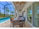 Screened-in pool area with dining table, fan and a view of the lake at 7538 Camden Harbour Dr, Bradenton, FL 34212