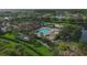 Aerial view of a community pool, clubhouse, playground and landscaping in a residential neighborhood at 7538 Camden Harbour Dr, Bradenton, FL 34212