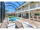 Expansive screened-in pool area with spa, outdoor bar, dining space, and inviting lounge chairs at 7538 Camden Harbour Dr, Bradenton, FL 34212