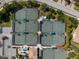 Aerial view of impeccably maintained tennis courts and lush landscaping at 7803 Grand Estuary Trl # 102, Bradenton, FL 34212