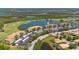 Stunning aerial view of lakeside condos with golf course, mature trees, and convenient covered parking at 7803 Grand Estuary Trl # 102, Bradenton, FL 34212