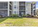 Well-maintained building with multiple screened lanais and lush landscaping at 7803 Grand Estuary Trl # 102, Bradenton, FL 34212