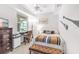 Bright bedroom featuring a window view, desk, and comfortable furnishings at 7803 Grand Estuary Trl # 102, Bradenton, FL 34212
