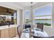 Cozy breakfast nook with large windows offering stunning water views, adjacent to a screened lanai at 7803 Grand Estuary Trl # 102, Bradenton, FL 34212