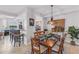 Charming dining area with setting for six and a view into the kitchen at 7803 Grand Estuary Trl # 102, Bradenton, FL 34212