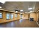 Bright exercise room with hardwood floors, large mirrors, fans, and windows, perfect for fitness and wellness activities at 7803 Grand Estuary Trl # 102, Bradenton, FL 34212