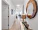 Neutral interior hallway with decor and view into the living room at 7803 Grand Estuary Trl # 102, Bradenton, FL 34212