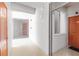 Bright hallway showing doors and exterior-facing window of condo unit at 7803 Grand Estuary Trl # 102, Bradenton, FL 34212
