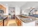 Bright kitchen with granite countertops, stainless steel appliances, open to the dining and living areas at 7803 Grand Estuary Trl # 102, Bradenton, FL 34212