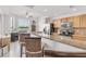 Well-equipped kitchen with granite counters, stainless steel appliances, and a breakfast bar with waterfront views at 7803 Grand Estuary Trl # 102, Bradenton, FL 34212