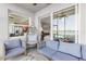 Cozy lanai featuring a hanging chair and comfortable seating with peaceful lake views at 7803 Grand Estuary Trl # 102, Bradenton, FL 34212