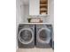 Efficient laundry room with modern washer and dryer, plus overhead storage at 7803 Grand Estuary Trl # 102, Bradenton, FL 34212