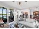 Comfortable living room with kitchen view, slider to lanai with lake view at 7803 Grand Estuary Trl # 102, Bradenton, FL 34212