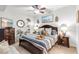 Relaxing bedroom with wood furnishings, fan, and beach-themed decor at 7803 Grand Estuary Trl # 102, Bradenton, FL 34212