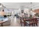 Open floor plan with dining area, living room, and kitchen offering lake views at 7803 Grand Estuary Trl # 102, Bradenton, FL 34212