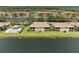 Breathtaking aerial view showcases lakeside condos with a community pool, perfectly blending residential comfort and natural beauty at 8304 Grand Estuary Trl # 104, Bradenton, FL 34212