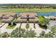 Aerial view of townhomes showing proximity to the golf course and lake at 8304 Grand Estuary Trl # 104, Bradenton, FL 34212