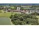 Impressive aerial view of a golf course community featuring a clubhouse, manicured greens, and scenic ponds at 8304 Grand Estuary Trl # 104, Bradenton, FL 34212