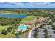 An inviting aerial perspective of a resort-style pool area and a meticulously maintained golf course community at 8304 Grand Estuary Trl # 104, Bradenton, FL 34212