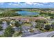 Stunning aerial view of a golf course community with a lake and meticulously landscaped grounds at 8304 Grand Estuary Trl # 104, Bradenton, FL 34212