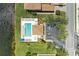 Aerial view of a community pool with ample lounge chairs, a covered patio, and parking at 8304 Grand Estuary Trl # 104, Bradenton, FL 34212