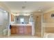 Bathroom with a walk-in shower, double vanity, and tiled floor and walls at 8304 Grand Estuary Trl # 104, Bradenton, FL 34212