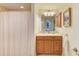 Well-lit bathroom featuring a vanity with wood cabinets, neutral countertops, and a shower/tub combo with a patterned curtain at 8304 Grand Estuary Trl # 104, Bradenton, FL 34212