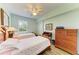 Charming bedroom with two twin beds, wood floors, ceiling fan, and a bright window at 8304 Grand Estuary Trl # 104, Bradenton, FL 34212