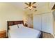 Inviting bedroom with a queen bed, white comforter, wood floors, a ceiling fan, and a closet, blending comfort and style at 8304 Grand Estuary Trl # 104, Bradenton, FL 34212