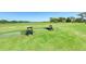 Driving range with well-maintained grass and lake views, ideal for practicing your swing at 8304 Grand Estuary Trl # 104, Bradenton, FL 34212
