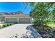 Inviting townhome exterior with a neatly paved driveway, well-manicured landscaping, and a welcoming two-car garage at 8304 Grand Estuary Trl # 104, Bradenton, FL 34212