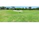 Expansive view of a well-maintained golf course, featuring lush green grass and a prominent sand trap at 8304 Grand Estuary Trl # 104, Bradenton, FL 34212