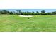 Expansive view of a well-maintained golf course, featuring lush green grass and a prominent sand trap at 8304 Grand Estuary Trl # 104, Bradenton, FL 34212