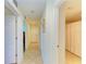 Hallway featuring tile flooring leading to a bathroom with a shower at 8304 Grand Estuary Trl # 104, Bradenton, FL 34212