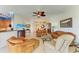 Open-concept living room with comfortable seating, tile floors, and an inviting atmosphere for entertaining at 8304 Grand Estuary Trl # 104, Bradenton, FL 34212