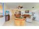 Spacious open-concept living room with leather furniture, connecting to the dining area at 8304 Grand Estuary Trl # 104, Bradenton, FL 34212