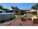 Spacious backyard featuring an above-ground pool and cozy patio seating, perfect for outdoor relaxation and entertainment at 9430 Glen Moor Ln, Port Richey, FL 34668