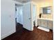 Bright bathroom with modern vanity, decorative mirror, and stylish lighting at 9430 Glen Moor Ln, Port Richey, FL 34668