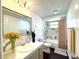 Bright bathroom with marble countertops, modern fixtures, and a shower-tub combination with stylish curtain at 9430 Glen Moor Ln, Port Richey, FL 34668