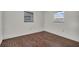 Bright bedroom with wood-look flooring and dual pane windows for ample natural light at 9430 Glen Moor Ln, Port Richey, FL 34668