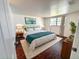 Cozy bedroom features natural light, soft rug, wood floors, and tasteful decor for a welcoming space at 9430 Glen Moor Ln, Port Richey, FL 34668