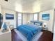 Relaxing bedroom features soothing blue accents, soft natural lighting, and modern decor at 9430 Glen Moor Ln, Port Richey, FL 34668