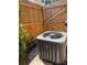 Exterior shot of a modern air conditioning unit with a wooden fence background at 9430 Glen Moor Ln, Port Richey, FL 34668