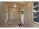 Covered front porch with tiled flooring and decorative window at 9430 Glen Moor Ln, Port Richey, FL 34668