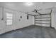 Attached garage with white walls, door to exterior, and overhead garage door at 9430 Glen Moor Ln, Port Richey, FL 34668