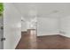 Open-concept living room with hardwood floors and neutral walls at 9430 Glen Moor Ln, Port Richey, FL 34668