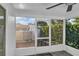 Screened in lanai with view of the pool, fence, and lush landscaping in the backyard at 9430 Glen Moor Ln, Port Richey, FL 34668