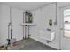 Utility room with sink and water heater at 9430 Glen Moor Ln, Port Richey, FL 34668