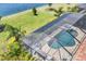 Aerial view showcases a pool, outdoor living space, and serene backyard at 7036 Highgate Ln, Lakewood Ranch, FL 34202